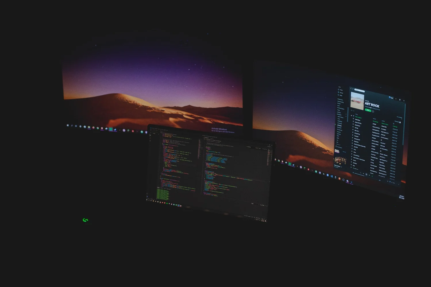 Developer workstations with code on screens
